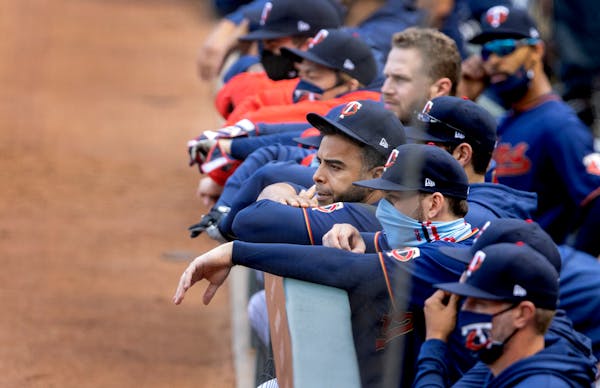 Twins players watched from the dugout in the ninth inning.