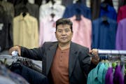 Long Her, a Hmong refugee, voted for Hillary Clinton in 2016, but now he's considering voting for Trump after his business, New Fashions Tailoring & A