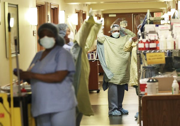 Healthcare workers don PPE at Bethesda Hospital in St. Paul.