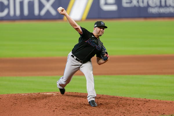 Miami's Brandon Kintzler delivers a pitch during the eighth inning in Game 2 of a National League Division Series vs. the Braves
