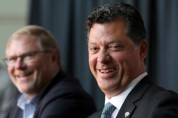 Wild owner Craig Leipold, left, laughs with general manager Bill Guerin at an introductory press conference in 2019.