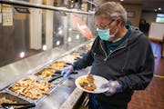 Bob Hemp of Brooklyn Park served himself wearing a mask and gloves at Golden Corral Buffet and Grill in Maple Grove.