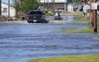 A truck drive through floodwaters in a neighborhood in Lake Charles, La., Saturday, Oct. 10, 2020, after Hurricane Delta moved through on Friday. (AP 