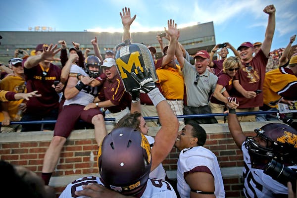 Gophers players and fans celebrated after winning the Little Brown Jug by beating Michigan in 2014.