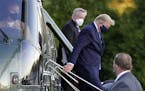 President Donald Trump arrives at Walter Reed National Military Medical Center, in Bethesda, Md., Friday, Oct. 2, 2020, on Marine One helicopter after