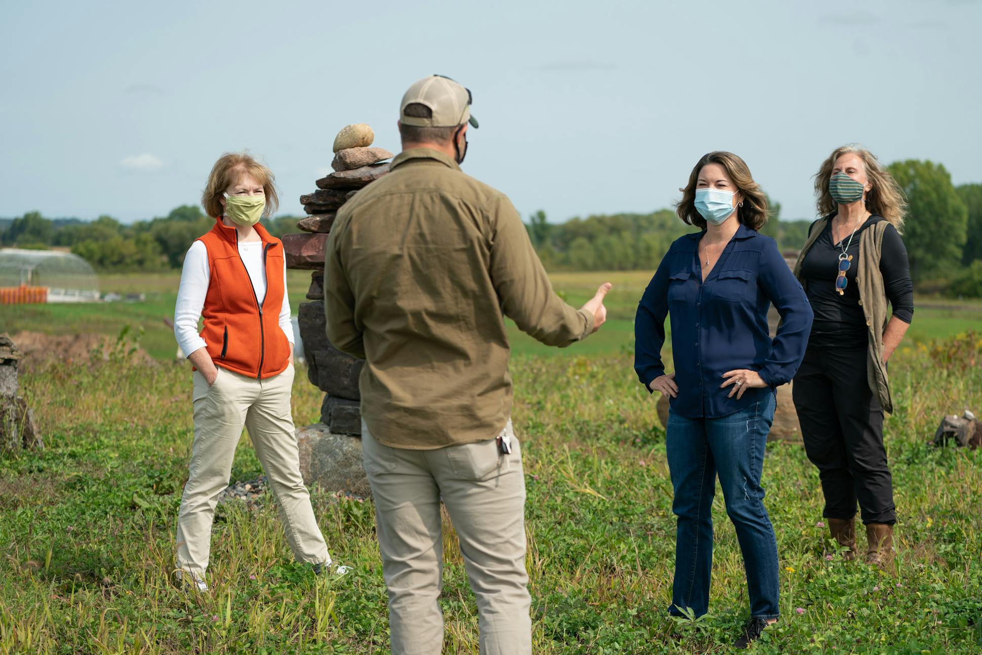 Sen. Tina Smith visited the Main Street Project Farm in Northfield, Minn., along with U.S. Rep. Angie Craig. They listened as co-farm manager Waytt Parks talked about the farm's mission.