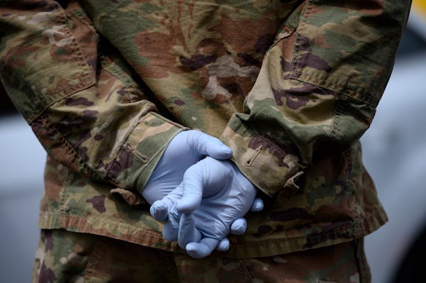 A Minnesota National Guardsman wore medical gloves to a free testing event at the Minneapolis Armory in May.