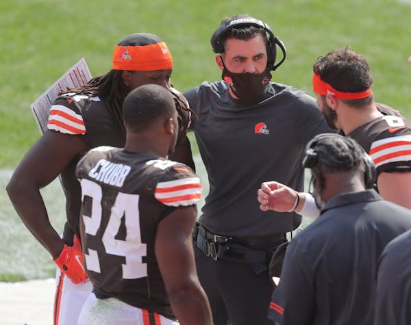 Cleveland Browns' head coach Kevin Stefanski talks with Nick Chubb, left, Kareem Hunt and Baker Mayfield during the game earlier this season.