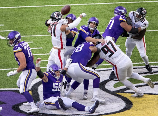 Jacob Tuioti-Mariner (91) of the Falcons deflects a pass by Vikings quarterback Kirk Cousins that was intercepted in the second quarter