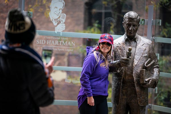 Emily Clausman of Minneapolis had her photo taken by her mother Cheryle Clausman with the statue of Sid Hartman at Target Center in downtown Minneapol