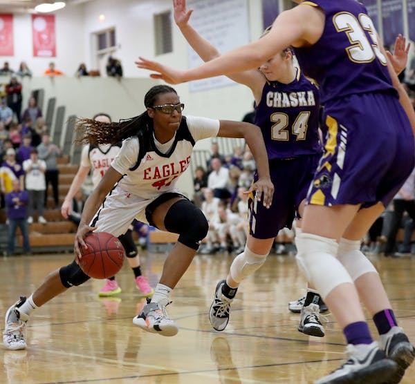 Eden Prairie’s Nia Holloway (41) drives to the basket against Chaska’s Mallory Heyer (24) during the second half of Eden Prairie’s win in the Cl