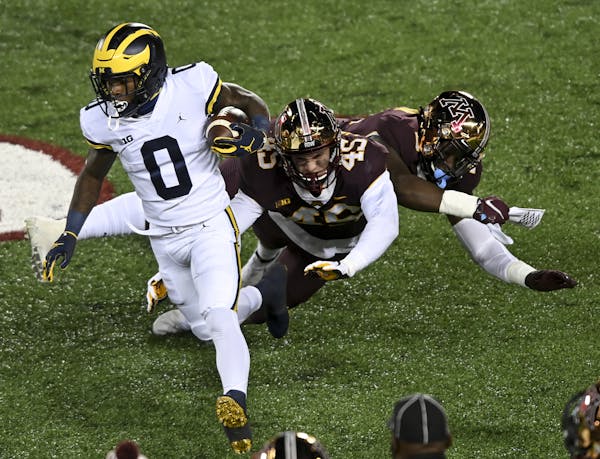 Minnesota Gophers defensive lineman MJ Anderson (3) and linebacker Cody Lindenberg (45) collided as they missed a tackle against Michigan Wolverines w