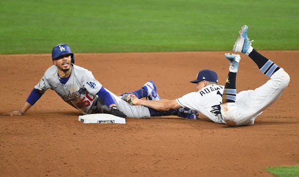 Los Angeles Dodgers' Mookie Betts steals second base in front of Tampa Bay Rays shortstop Willy Adames in the sixth inning in Game 3 of the World Seri