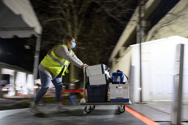 Anna Baish, a volunteer and student at the University of Minnesota, pushed a dolly holding completed ballots and election equipment into the warehouse