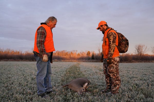 Travis Pennings and his uncle Dan Pennings stopped to look over a deer Travis shot in 2018.