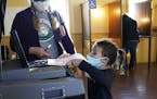 Laura Gesme of Vasa got help from daughter Isla, 4, while voting Tuesday at the Vasa Town Hall in Welch, Minn.