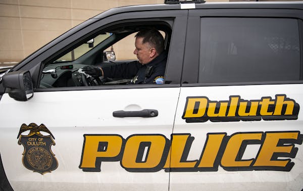 Duluth police Sgt. Steven Ring disinfected his squad car after his shift. The department has been hit by soaring numbers in the Northland, though it w