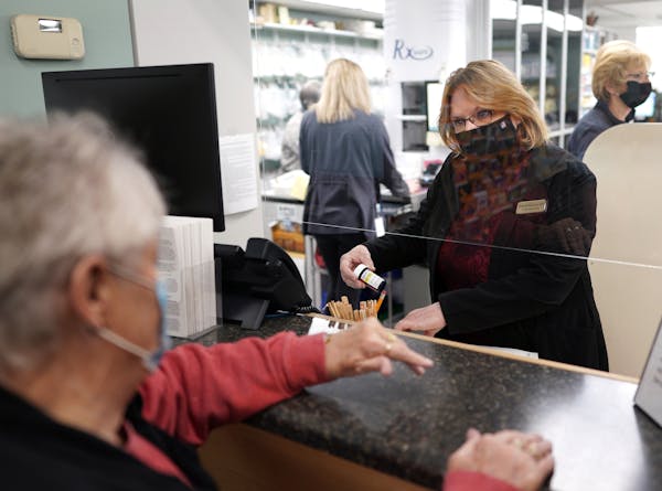 Deborah Keaveny, pharmacist at Keaveny Drug in Winsted, Minn., fills a prescription for Ruth, a longtime customer. Small, independent pharmacies are c