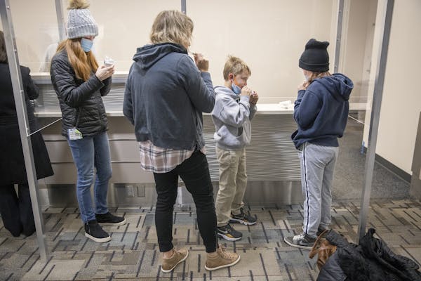 Heidi Smith and her children, Ella, 15, Nolan, 8, and Amelia, 12, took advantage of the new saliva COVID-19 testing site at the Minneapolis-St. Paul I
