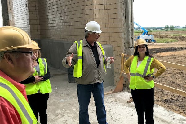 MPCA Commissioner Laura Bishop, right, visited the under-construction Premium Minnesota Pork plant in Luverne in 2019.