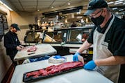 Meat cutter Mark Walfoort donned personal protective equipment while displaying tenderloin beef at a Lunds & Byerlys in Roseville. Walfoort keeps 10 w