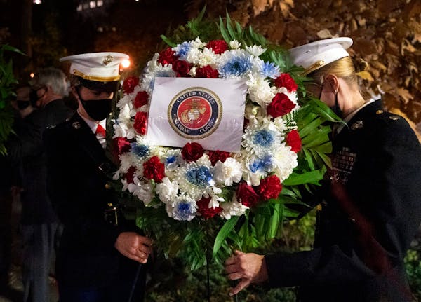 A Navy and Marine Corps honor guard lays a wreath at the Eternal Light Flagstaff in Madison Square Park, Wednesday, Nov. 11, 2020 in New York. The cer