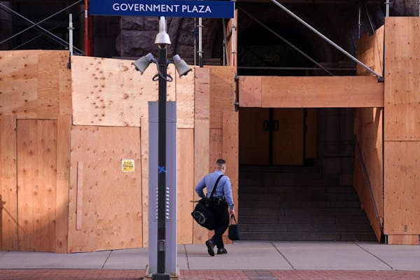 A lone Minneapolis Police officer walked to City Hall with a bag of riot gear as news circulated that Democratic Presidential candidate Joe Biden was 