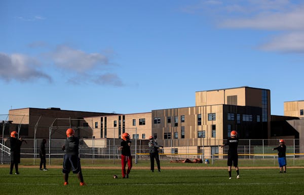 Football players stretched out during practice Sept. 28 at Humboldt High School in St. Paul.