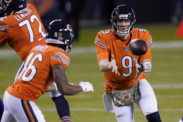 Chicago Bears quarterback Nick Foles (9) laterals to running back Artavis Pierce (46) during the second half of an NFL football game against the Minne