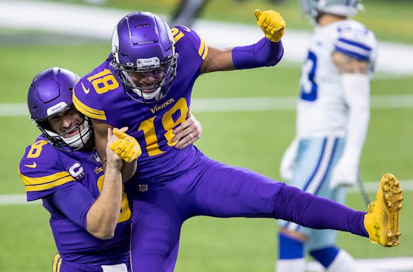 Minnesota Vikings quarterback Kirk Cousins (8) and receiver Justin Jefferson (18) celebrated a 39-yard touchdown pass in the fourth quarter.