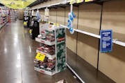Shelves at a grocery store sat empty in Happy Valley, Ore., on Nov. 14, the day after the governor announced new restrictions.