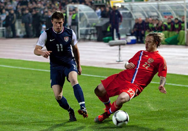 Joshua Gatt, left, played for the United States in a game in Russia in November 2012.