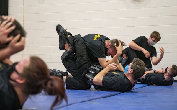 Trainees practiced ground-fighting techniques during defensive-tactics class at Fond du Lac Tribal and Community College in Cloquet, Minn.