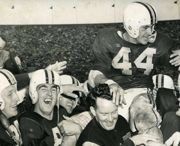 Bob McNamara, described as “touchdown ace” by the Minneapolis Tribune in this photo from Nov. 13, 1954, was carried off by the field by coach Murr