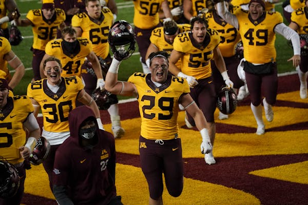 Gophers linebacker Josh Aune ran off the field cheering with teammates after the Gophers won 34-31 and Aune had a crucial interception in the last min
