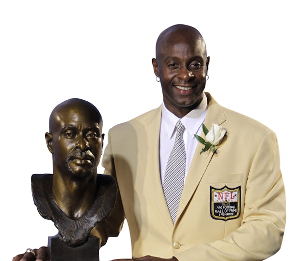 Former San Francisco 49ers great Jerry Rice poses with his bust after enshrinement in the Pro Football Hall of Fame in Canton, Ohio Saturday, Aug. 7, 
