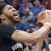 New Orleans Pelicans' Anthony Davis, right, lays up as Minnesota Timberwolves' Kris Dunn defends during the second half of an NBA basketball game Frid