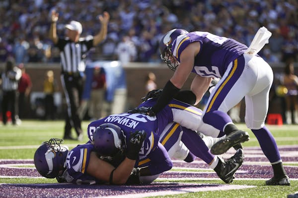 Linebacker Chad Greenway (52) celebrated his interception return against San Diego with fellow veteran Terence Newman.