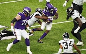 Minnesota Vikings running back Dalvin Cook (33) rushed the ball as Jacksonville Jaguars linebacker Joe Giles-Harris (43) made the tackle in the second