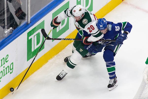 Wild defenseman Ryan Suter (20) battled Vancouver’s Jay Beagle as the teams met in an NHL postseason game in Edmonton on Aug. 2. The Wild’s season