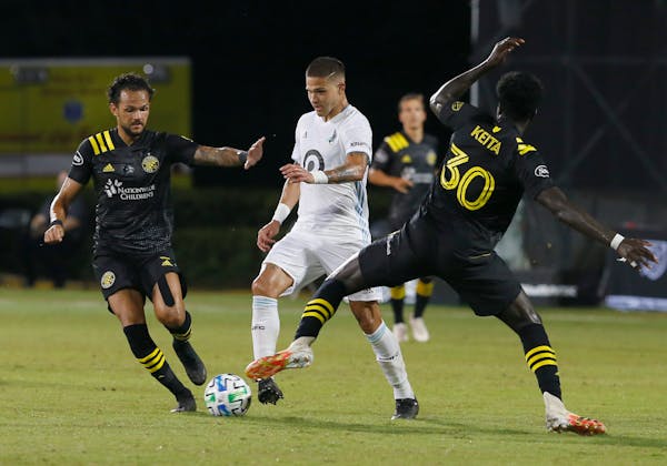 Minnesota United forward Luis Amarilla worked between Columbus players in July in the MLS is Back bubble in Florida.