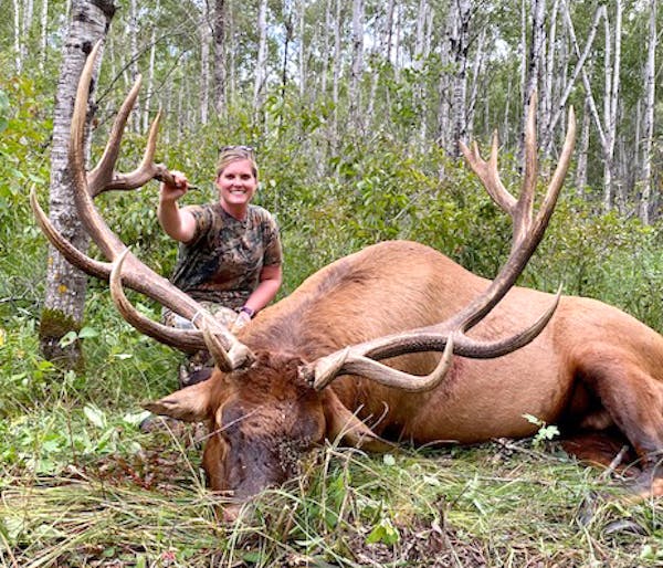 Lacey Lupien, 33, of Lancaster, Minn., with the giant elk she shot 3 miles from her home in Kittson County. She harvested the bull in August, and it w