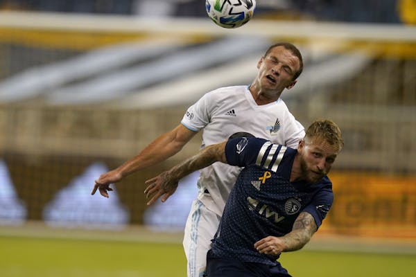 The Loons’ Chase Gasper, top, and Sporting KC’s Johnny Russell battled during a 1-0 Minnesota road loss Sept. 13.