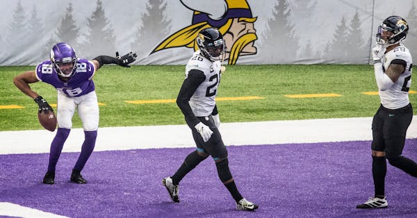 Vikings wide receiver Justin Jefferson celebrated his 20-yard touchdown catch in the third quarter as Jaguars free safety Jarrod Wilson, center, and J