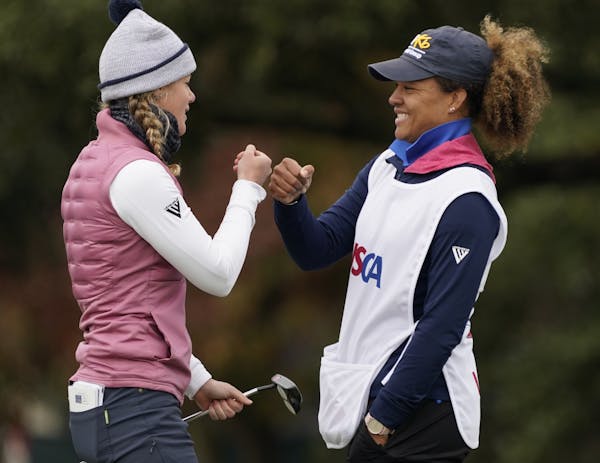 Amy Olson gave caddie Taneka Sandiford a fist bump after making a birdie on the 18th hole of the final round of the U.S. Women’s Open in Houston.
