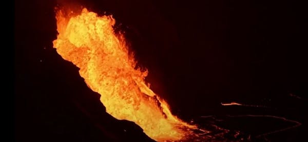Lava cascades into molten lake in volcano's crater
