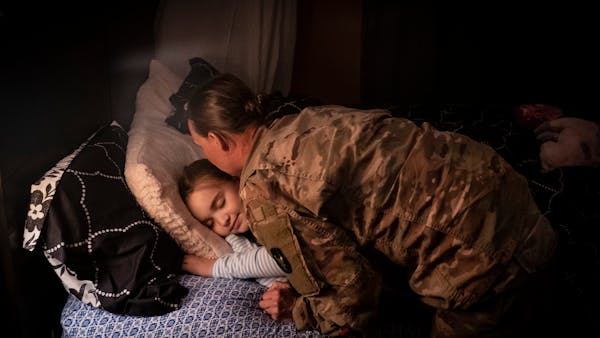 First Sgt. Jen Chaffee kissed her daughter Madison while putting her to bed after arriving home late at night after a year deployment in the Middle Ea