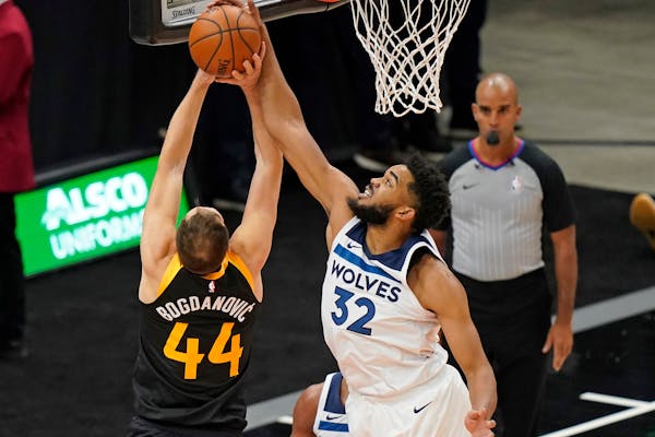 Wolves center Karl-Anthony Towns blocked Jazz forward Bojan Bogdanovic during the first half Saturday night in Salt Lake City.