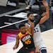 Utah Jazz guard Donovan Mitchell (45) and Minnesota Timberwolves center Karl-Anthony Towns (32) battle for position under the boards Saturday.