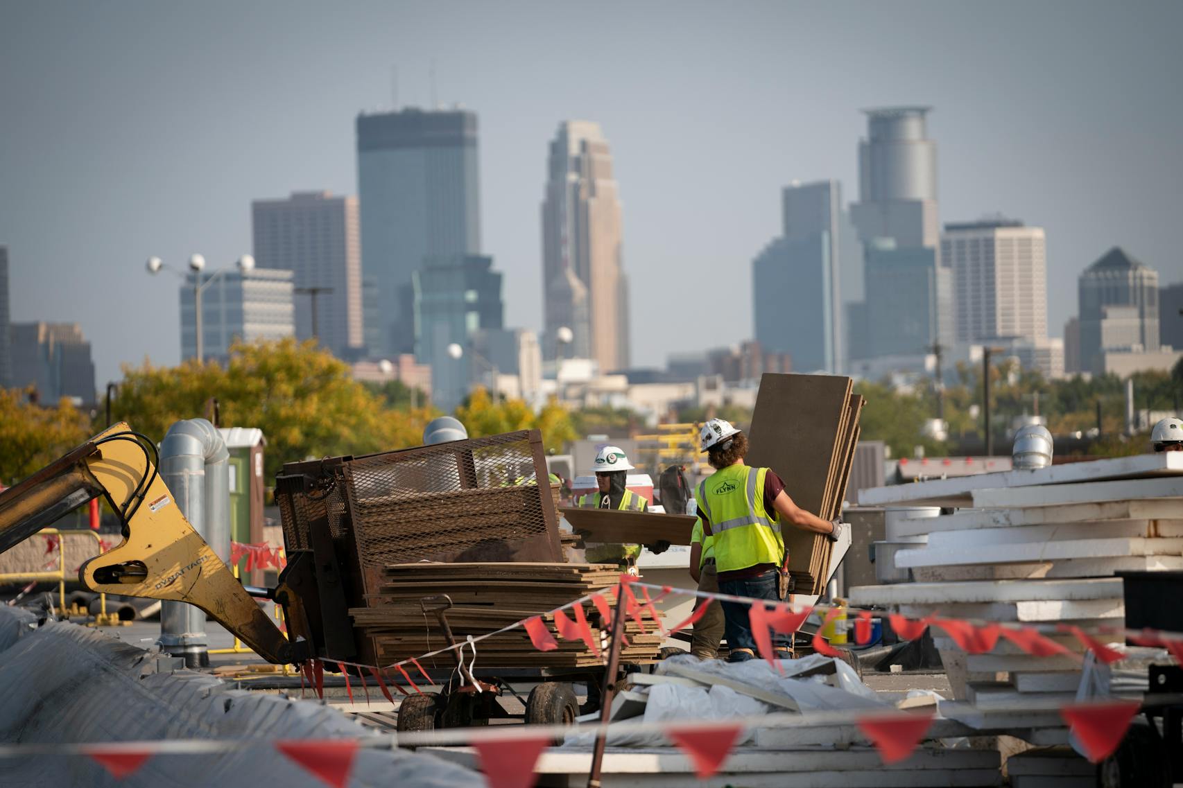 Construction workers worked on the roof of Highland Plaza that has a direct view of the Minneapolis skyline.